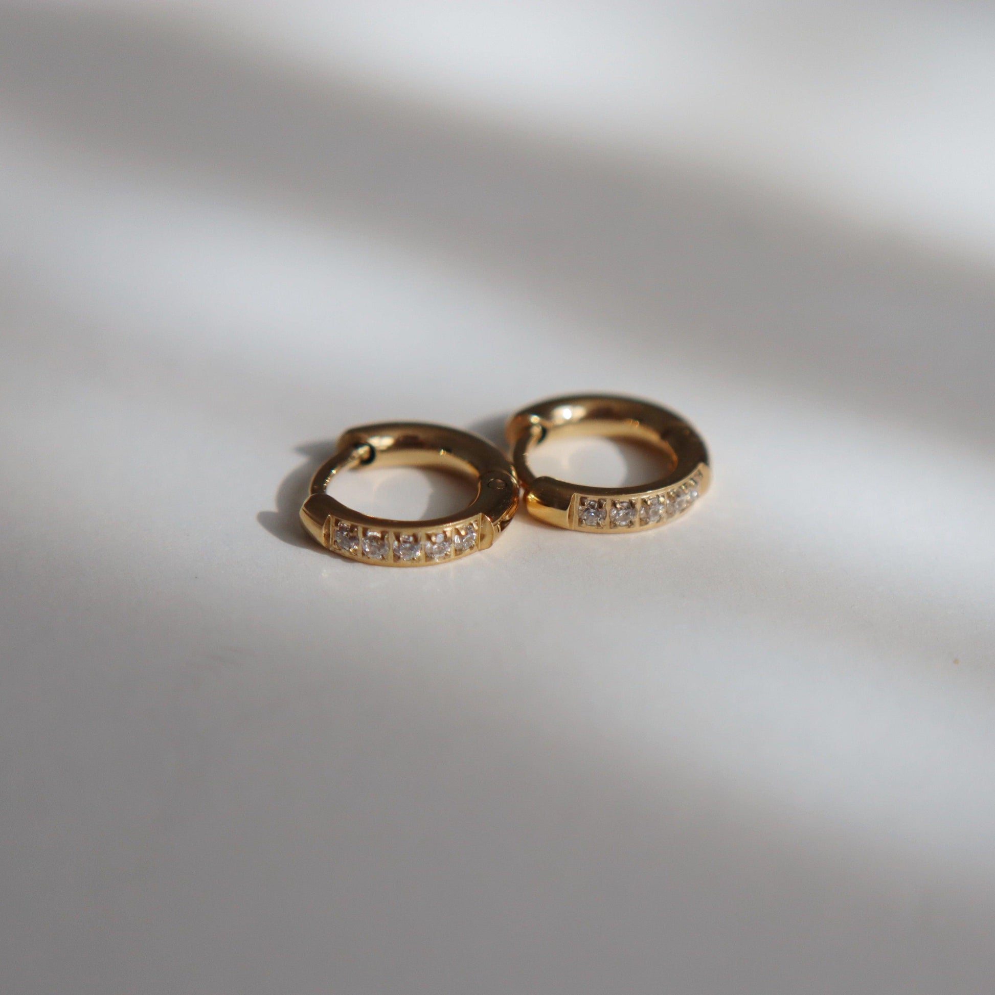 Hailey Huggies | Dainty CZ Huggies - JESSA JEWELRY | GOLD JEWELRY; dainty, affordable gold everyday jewelry. Tarnish free, water-resistant, hypoallergenic. Jewelry for everyday wear