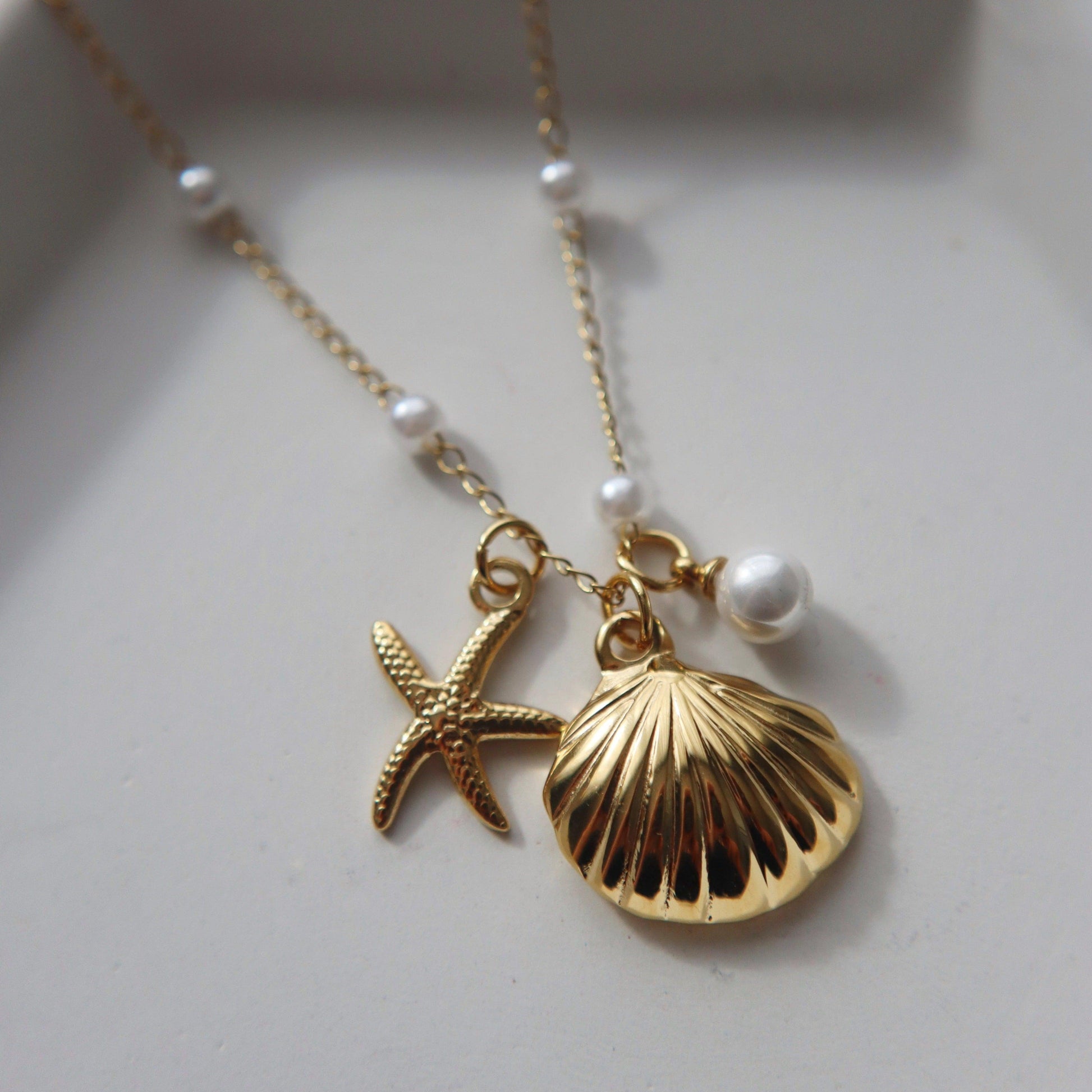 By the Shore Necklace | Shell and Star Pendant - JESSA JEWELRY | GOLD JEWELRY; dainty, affordable gold everyday jewelry. Tarnish free, water-resistant, hypoallergenic. Jewelry for everyday wear