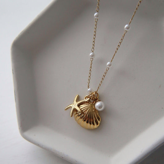 By the Shore Necklace | Shell and Star Pendant - JESSA JEWELRY | GOLD JEWELRY; dainty, affordable gold everyday jewelry. Tarnish free, water-resistant, hypoallergenic. Jewelry for everyday wear