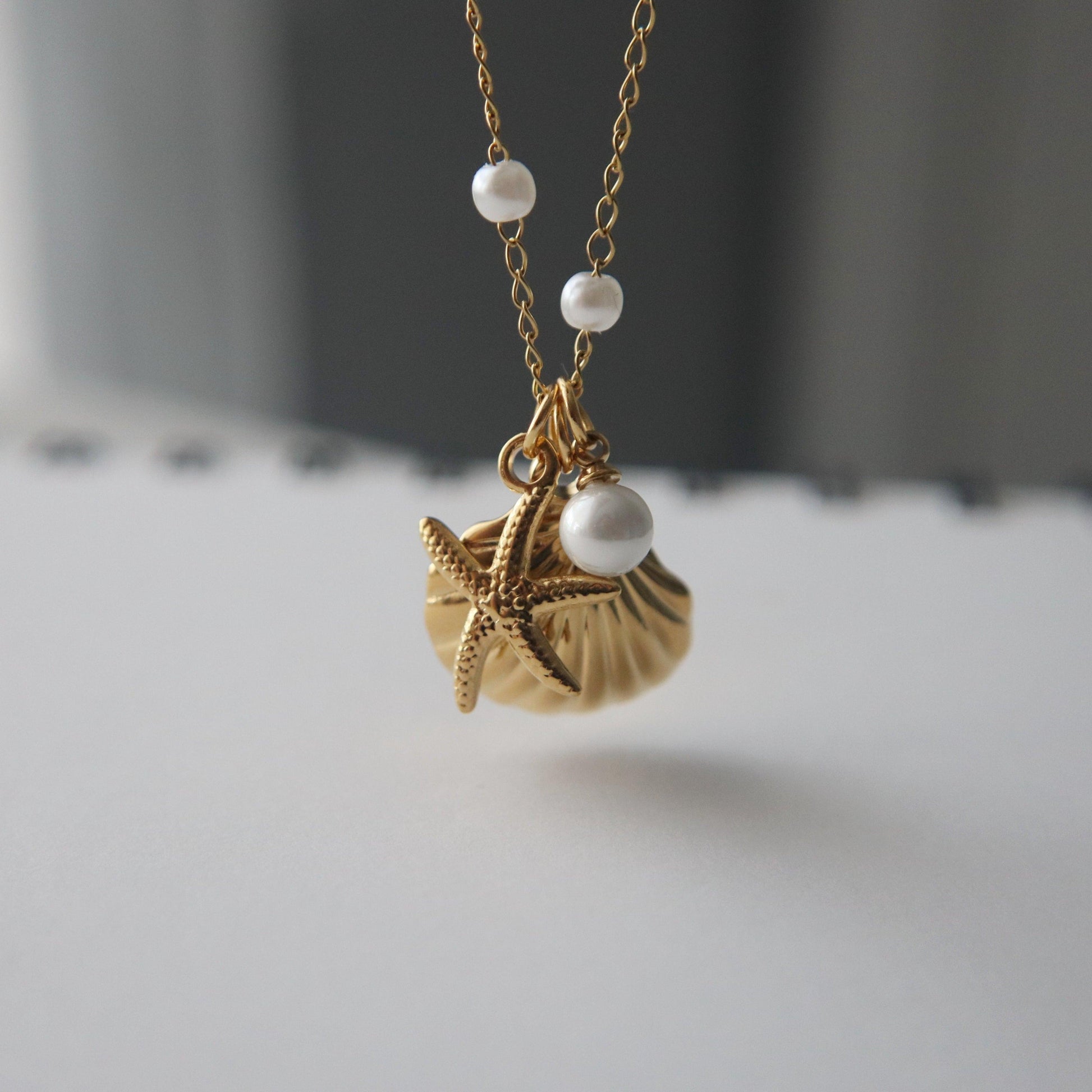 By the Shore Necklace | Shell and Star Pendant - JESSA JEWELRY | GOLD JEWELRY; dainty, affordable gold everyday jewelry. Tarnish free, water-resistant, hypoallergenic. Jewelry for everyday wear