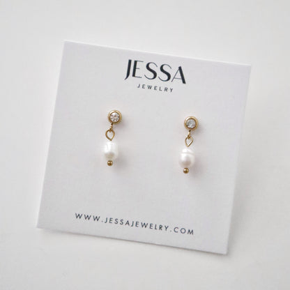 Pearl earrings on a Jessa Jewelry card with a white background